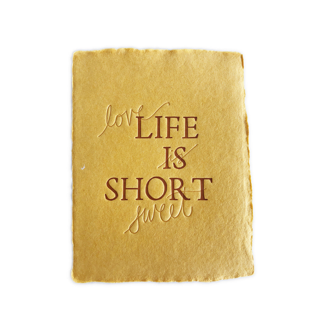 Yellow textured card with brown text saying, “Life is Short Love is Sweet”. A gray envelope is included.