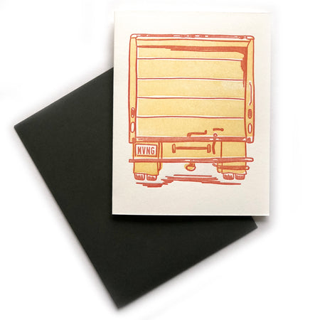 Ivory card with image of the back of a yellow moving truck with the license plate saying, “MVNG”. A dark gray envelope is included.