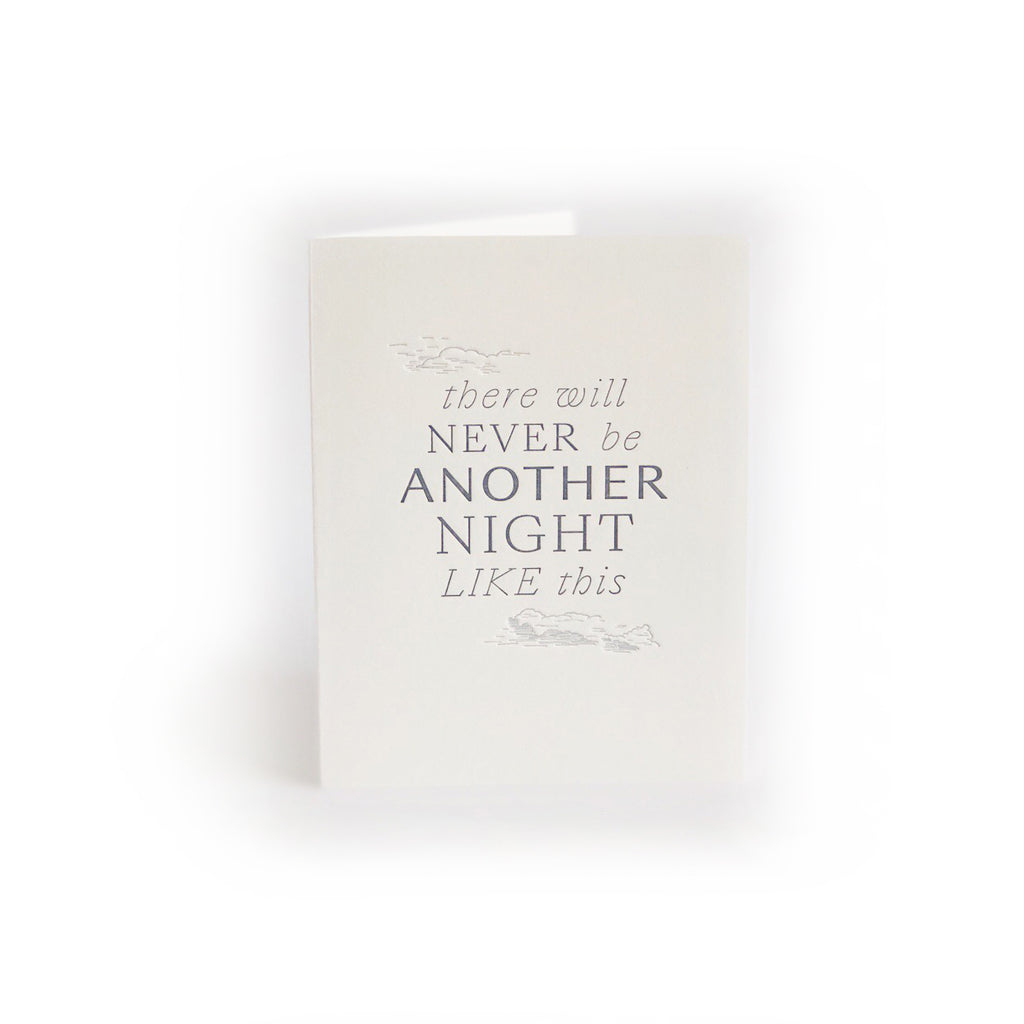 Ivory card with gray text saying, “There Will Never Be Another Night Like This”. Image of gray embossed clouds. A gray envelope is included.
