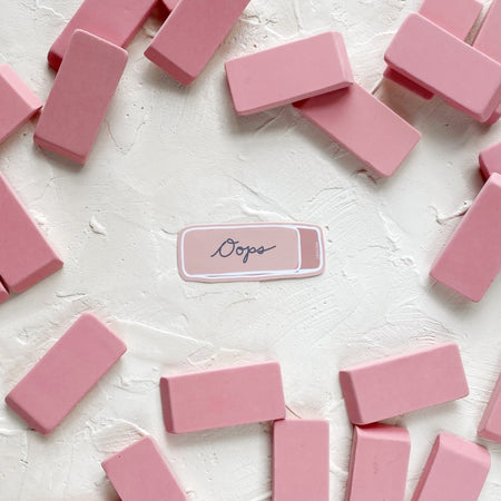 Rectangular pink sticker in the image of a classic pink eraser with black text saying, “Ooops” in the center.