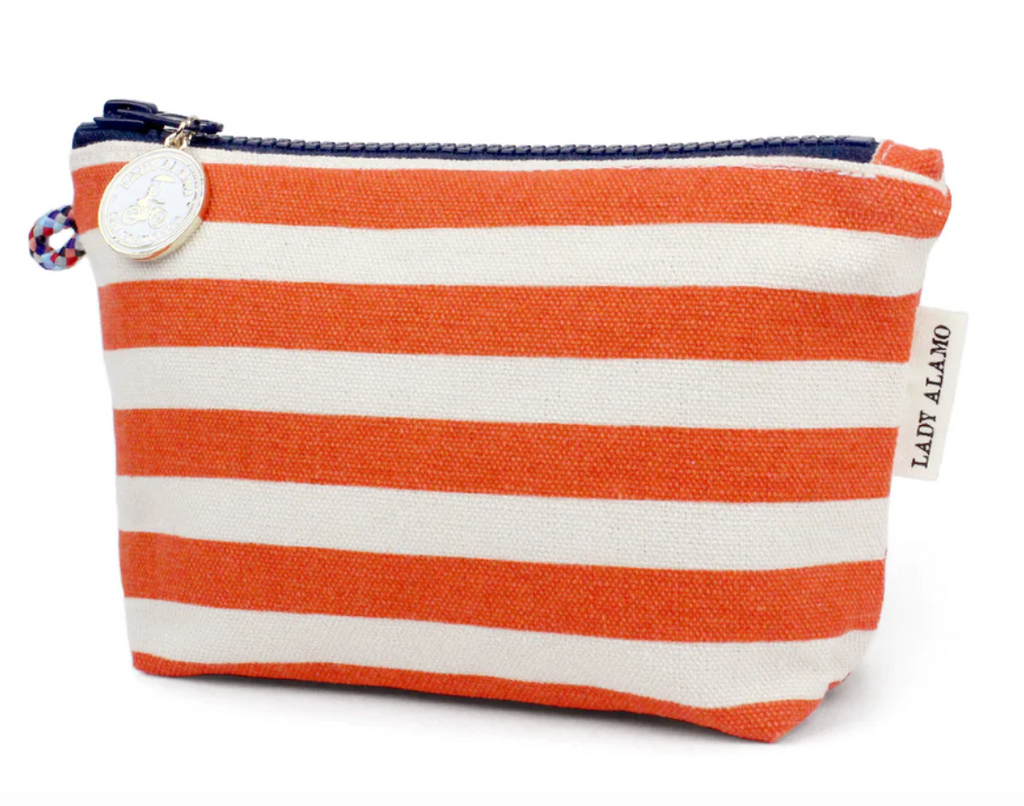 Rectangular travel pouch with orange and white stripe design. Navy blue zipper across the top.