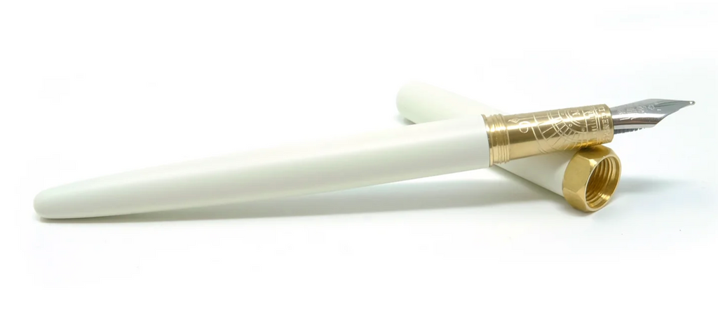 Ivory pen with gold banding and silver nib tip. Ivory cap. Packaged in ivory rectangular box with gold text saying 