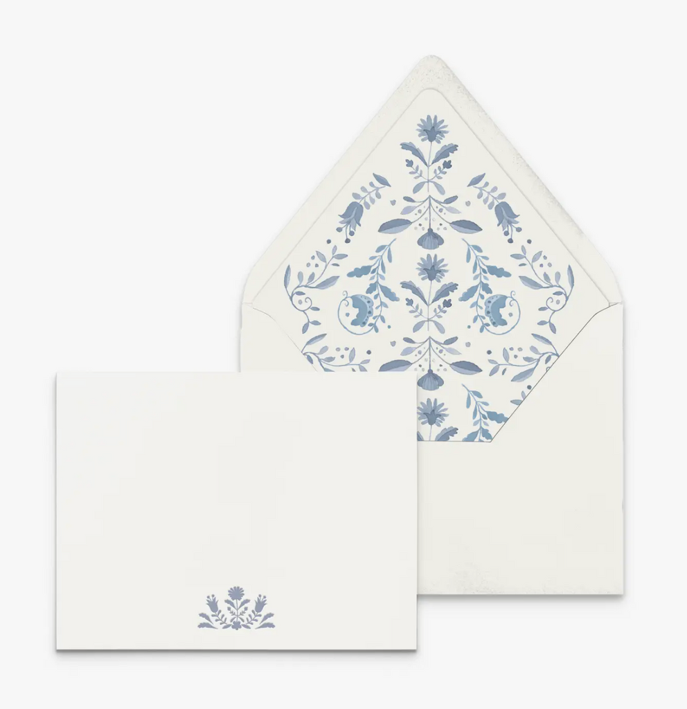 White notecards with blue floral design in center bottom. White envelope with blue floral design on inside flap included.