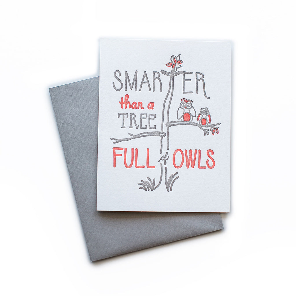 White card with gray and red text saying, “Smarter Than A Tree Full of Owls”. Images of a tree with a pair of owls sitting on a tree branch. A gray envelope is included.