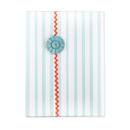 White gift wrap with blue teal vertical stripes.