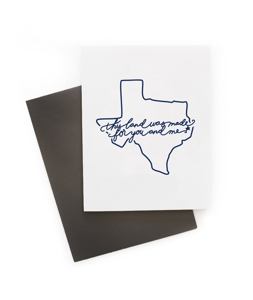 White card with blue text saying, “This Land is Made for You and Me”. Blue outline image of the state of Texas. A gray envelope is included.