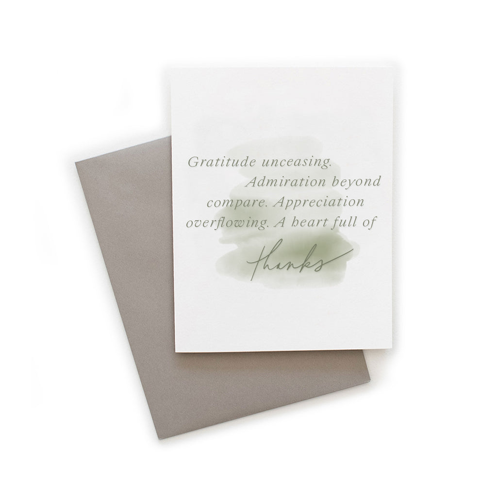 White card with muted watercolor wash in green tones with green text saying, “Gratitude unceasing. Admiration beyond compare. Appreciation overflowing. A heart full of thanks.” A gray envelope is included.