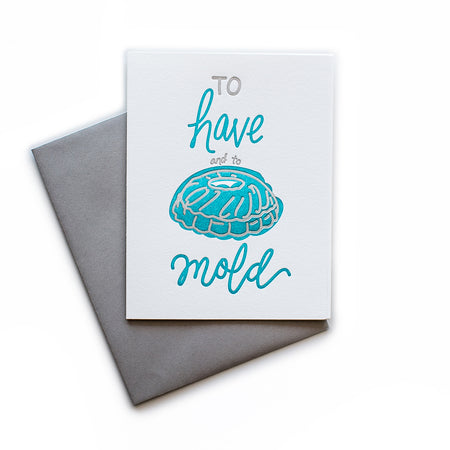 White card with gray and blue text saying, “To Have and to Mold”. Image of a blue jello ring mold. A gray envelope is included.