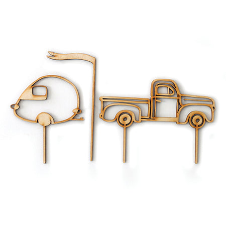 Wooden cutout cake topper in the images of a vintage camper, truck and flag pennant.