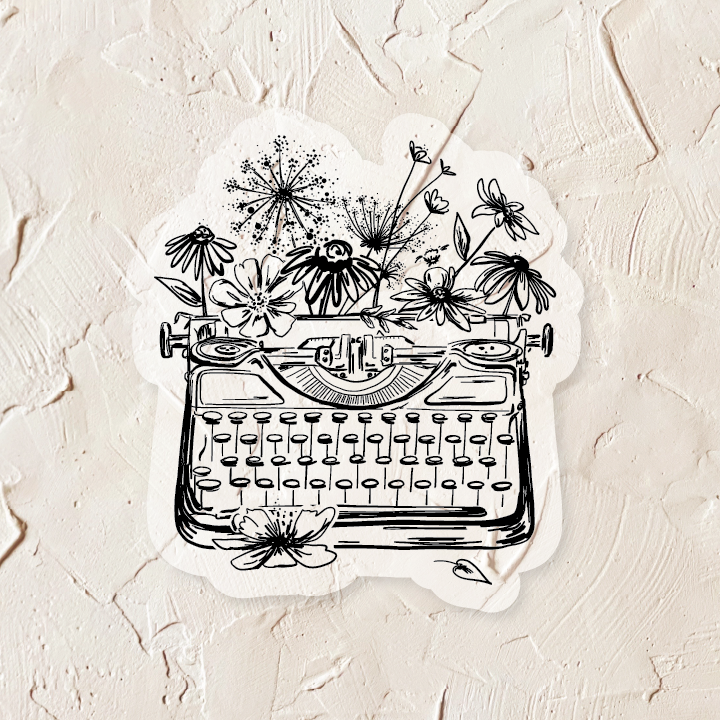 Ivory sticker with black ink. Images of a vintage typewriter and flowers. 