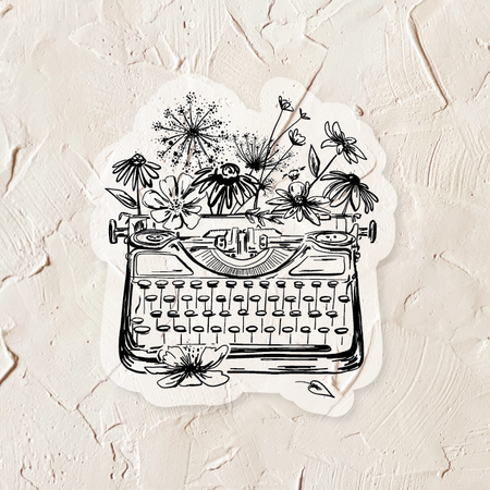 Ivory sticker with black ink. Images of a vintage typewriter and flowers. 