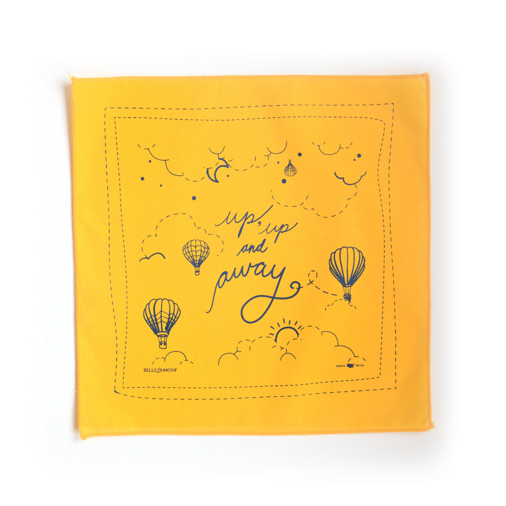 Yellow square with navy blue text saying, “Up Up and Away”. Images of blue hot air balloons and clouds.