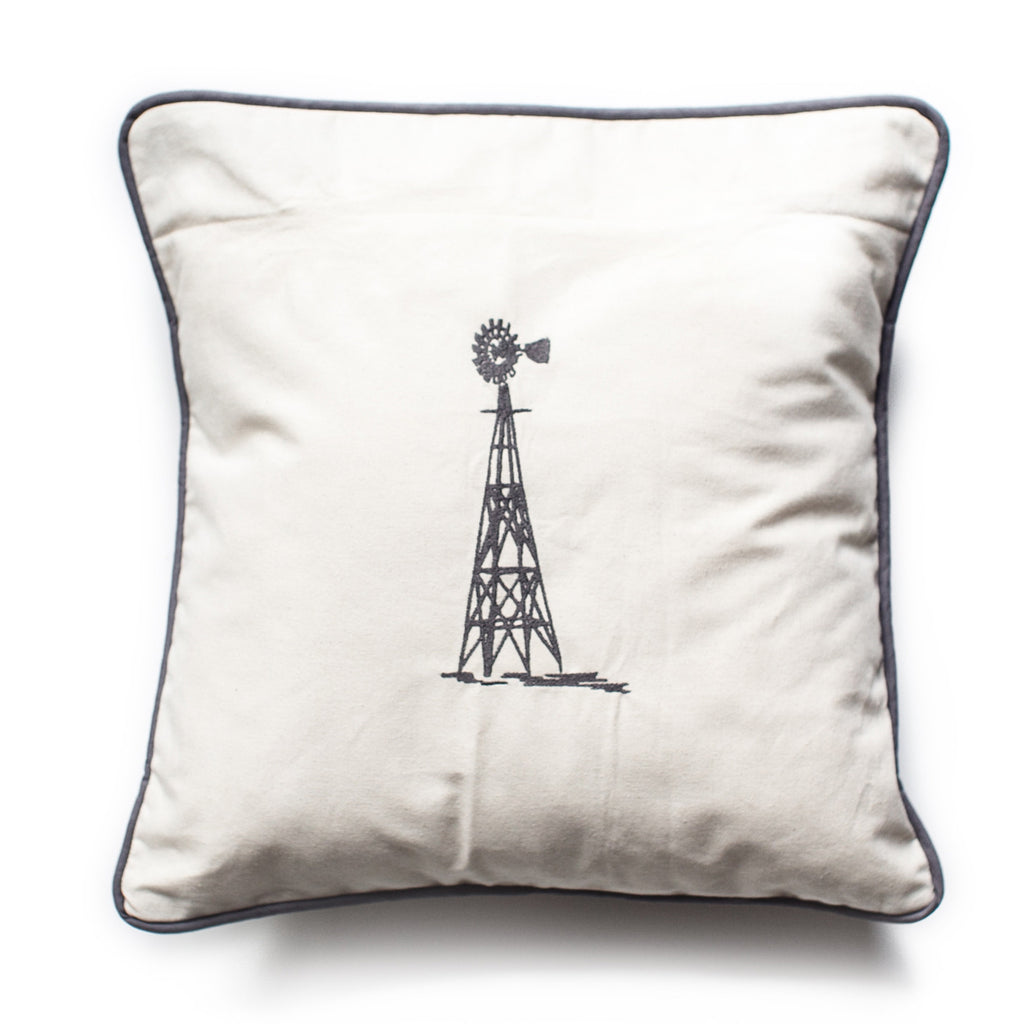 Pillow with ivory background and black edging with image of a metal farm windmill.