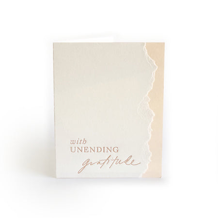 Ivory and pink card with curved torn edging where the two colors meet with rose text saying, “With Unending Gratitude”. An ivory envelope is included.