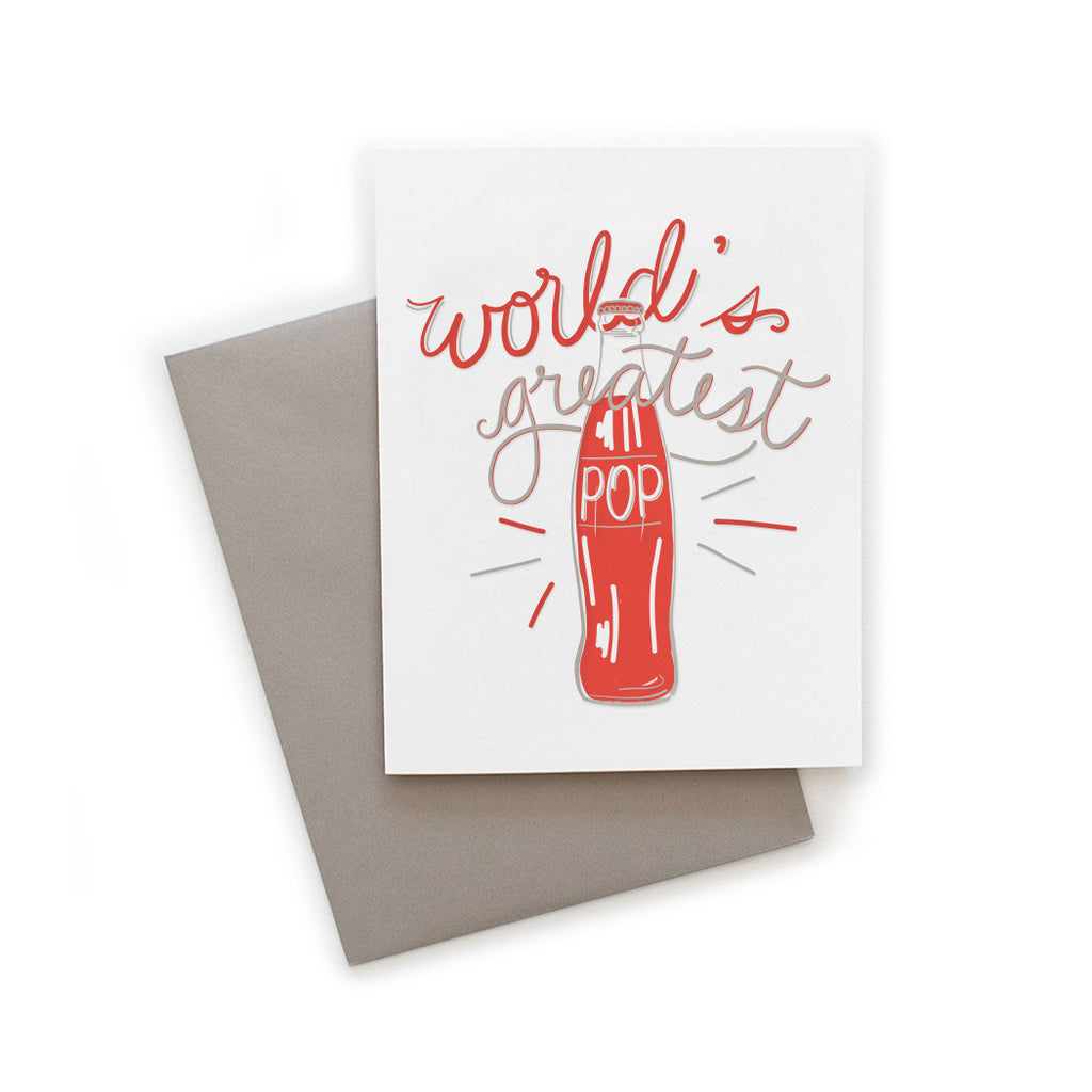 White card with gray and red text saying, “World’s Greatest Pop”. Image of a red vintage soda pop bottle. A gray envelope is included.