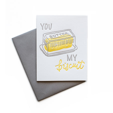 White card with gray and yellow text saying, “You Butter My Biscuit”. Image of a butter dish with a yellow stick of butter. A gray envelope is included.