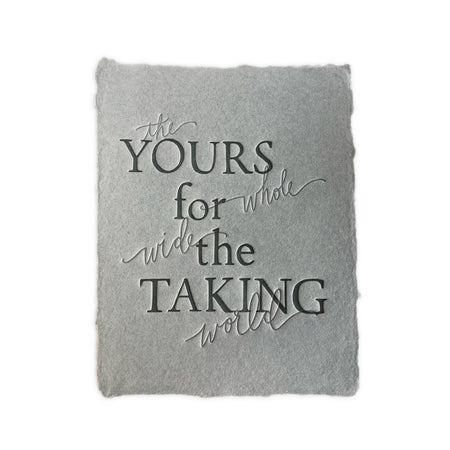 Gray textured card with gray text saying, “The Whole Wide World Yours For the Taking”. A gray envelope is included.