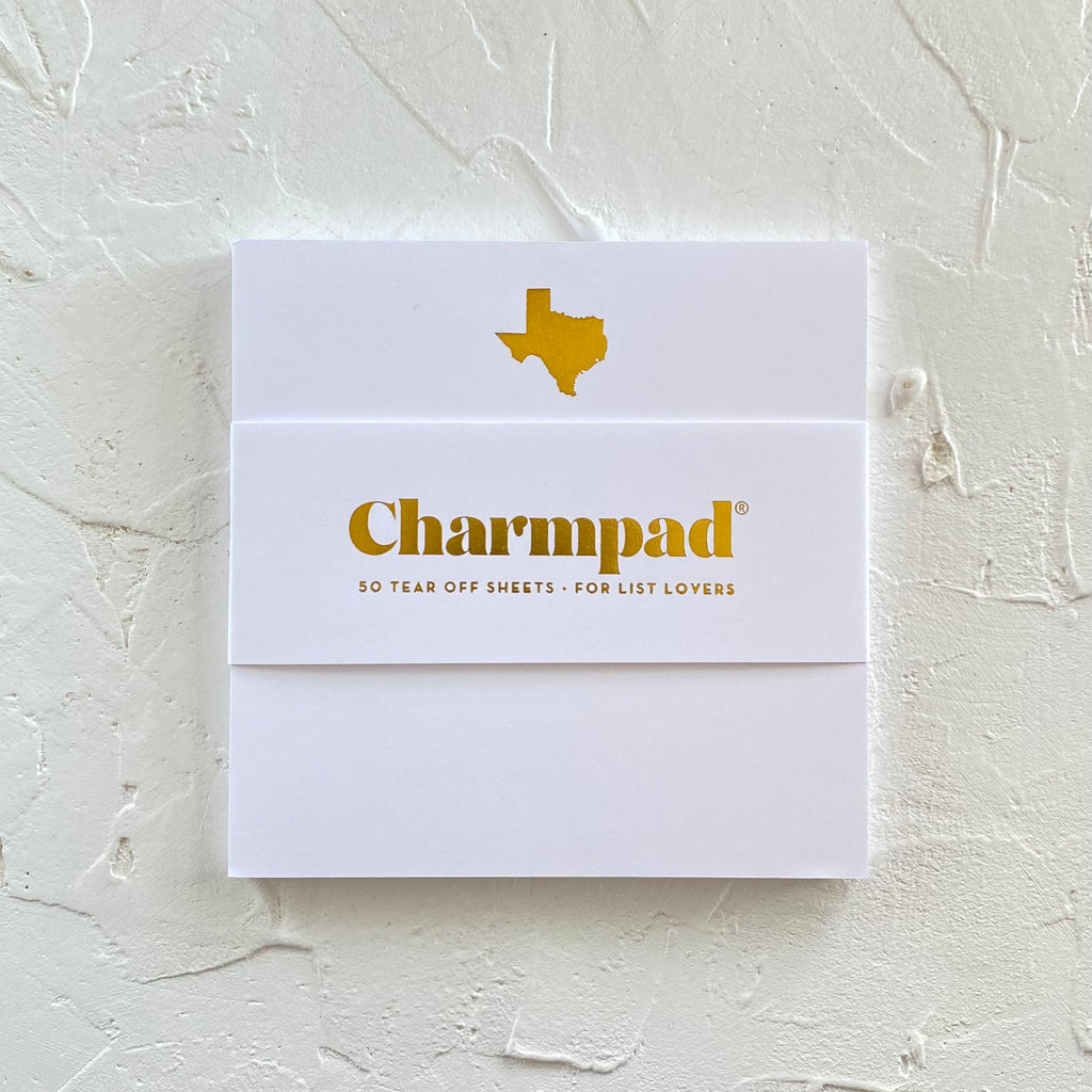 White square notepad with a gold foil image of the state of Texas in top center.