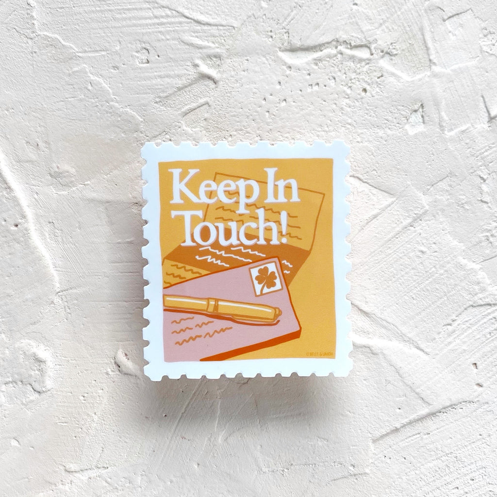 Sticker image of a postage stamp with gold background with a letter, envelope and pen. White text saying, “Keep in Touch”. 