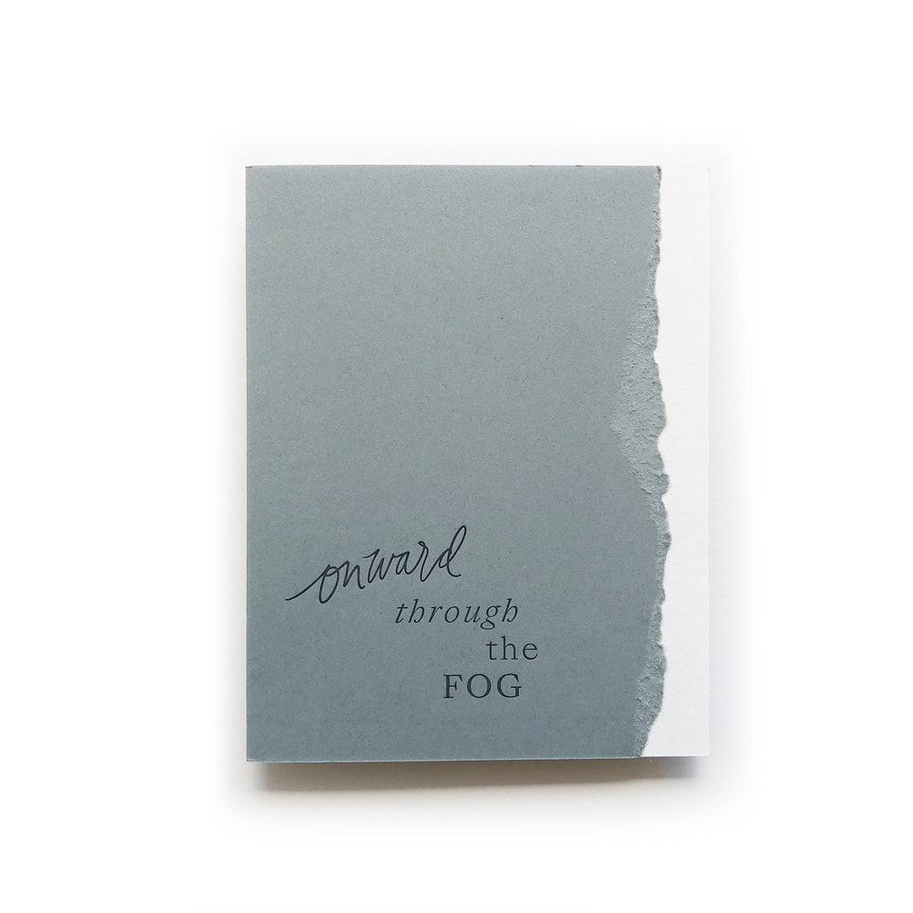 White and gray card with curved torn edging where the two colors meet. Gray text saying, “Onward Through the Fog”. A white envelope is included.