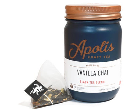 Blue jar with brass lid and white label. Brown text saying, “Apolis Craft Tea”. White label with blue and red text saying, “Vanilla Chai Black Tea Blend”.